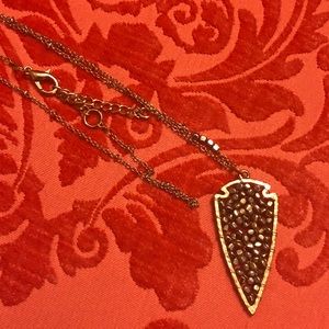 Francesca’s long gold and silver arrow necklace